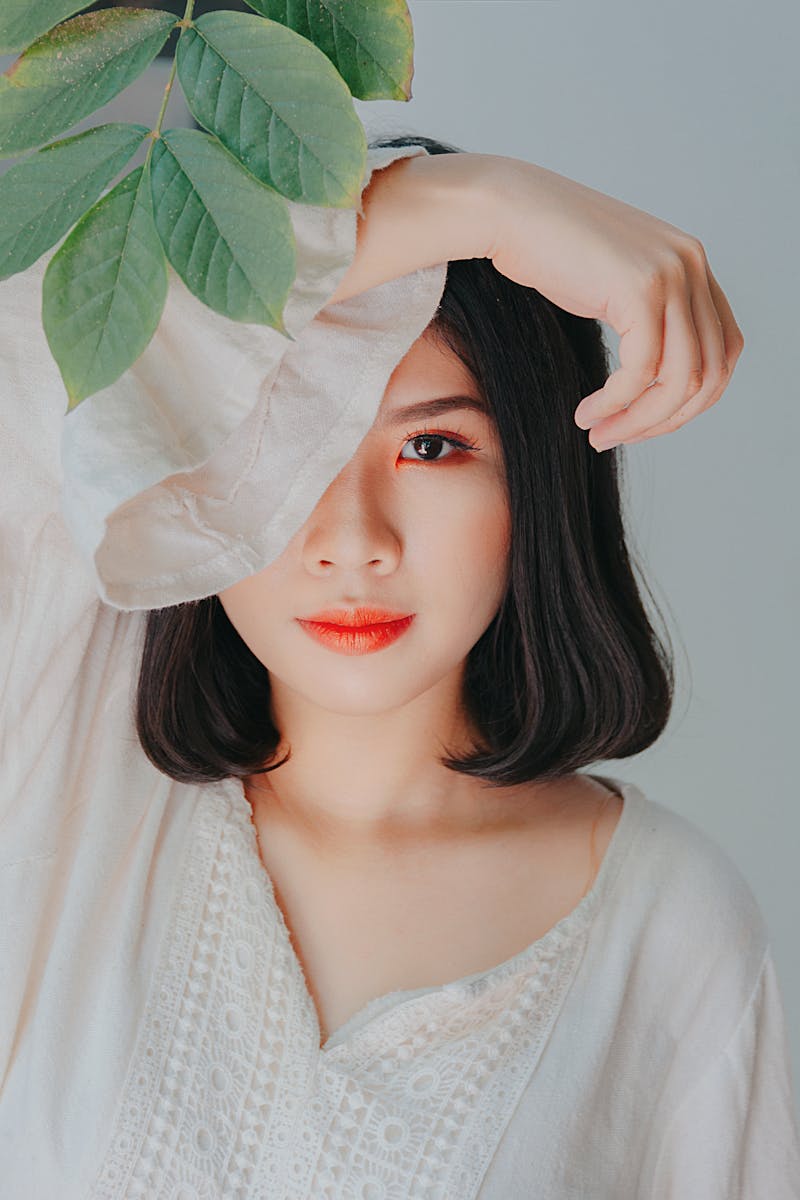 Serene portrait of a woman with leaves, perfect for beauty and nature themes.