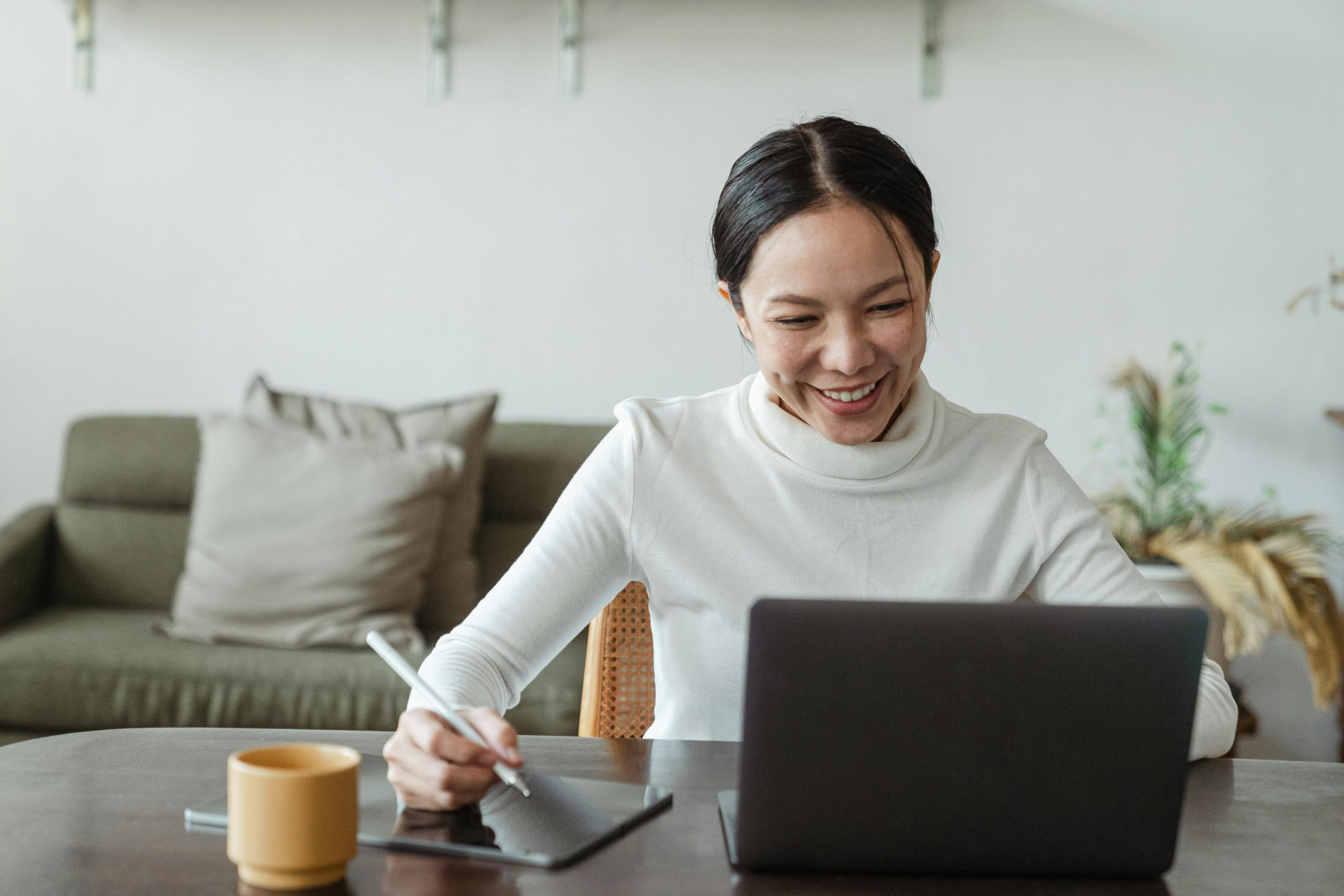 Woman using laptop and tablet for digital learning